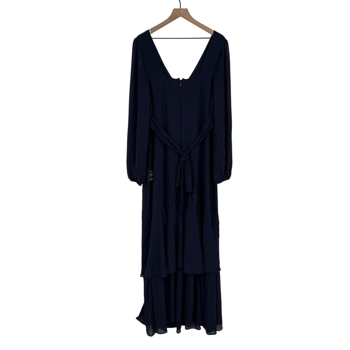 Navy blue dress on a hanger against a white background