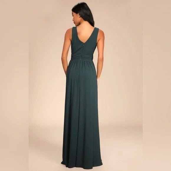 Woman wearing a dark green dress against a beige background