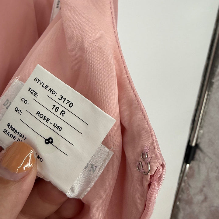 Close-up of a clothing tag on a pink garment with a blurred background