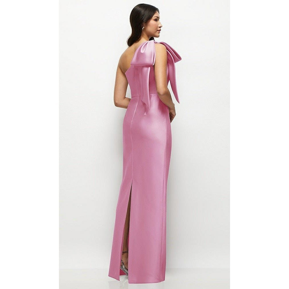 Pink evening gown with a large bow detail on a white background