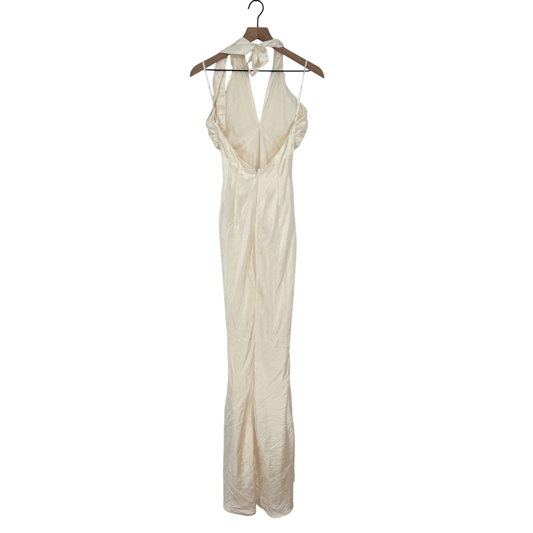 Beige evening gown on a hanger against a white background