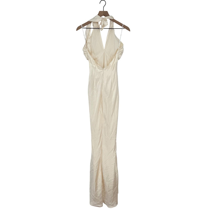 Beige evening gown on a hanger against a white background