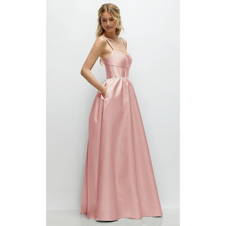 Woman wearing a pink evening gown against a white background