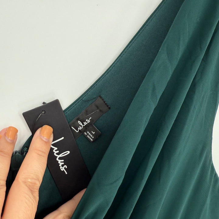 Teal fabric with a visible label on a light gray background
