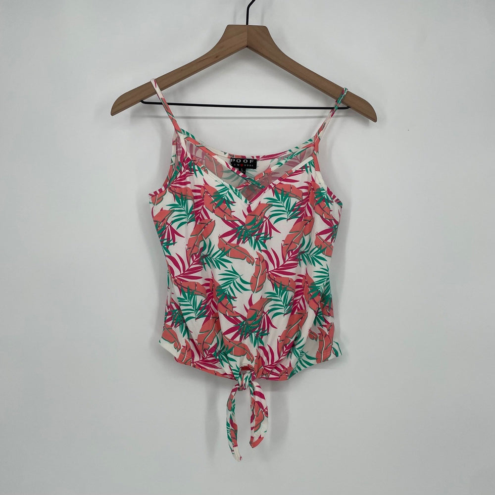 Floral patterned top on a hanger against a white background