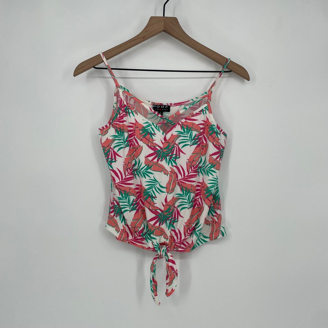 Floral patterned top on a hanger against a white background