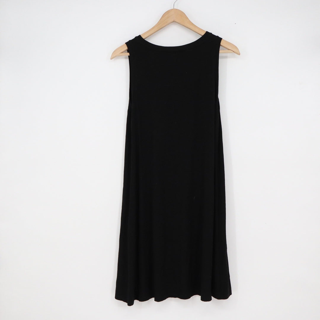 Black sleeveless dress on a wooden hanger against a white background