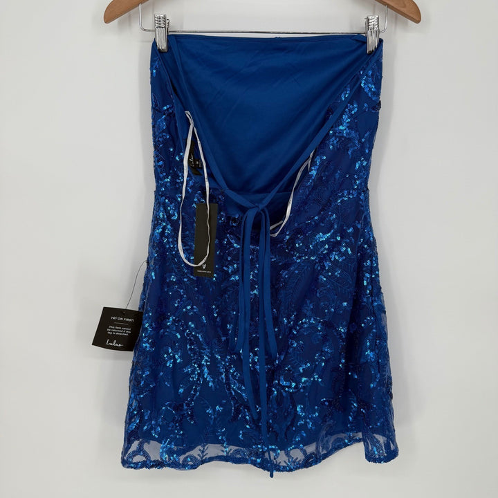 Blue sequin dress on a hanger against a white background