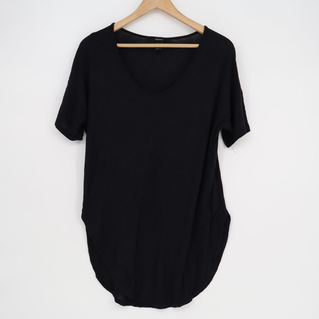 Black t-shirt on a wooden hanger against a white background