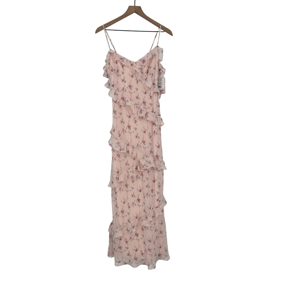 Pink floral dress on a hanger against a white background