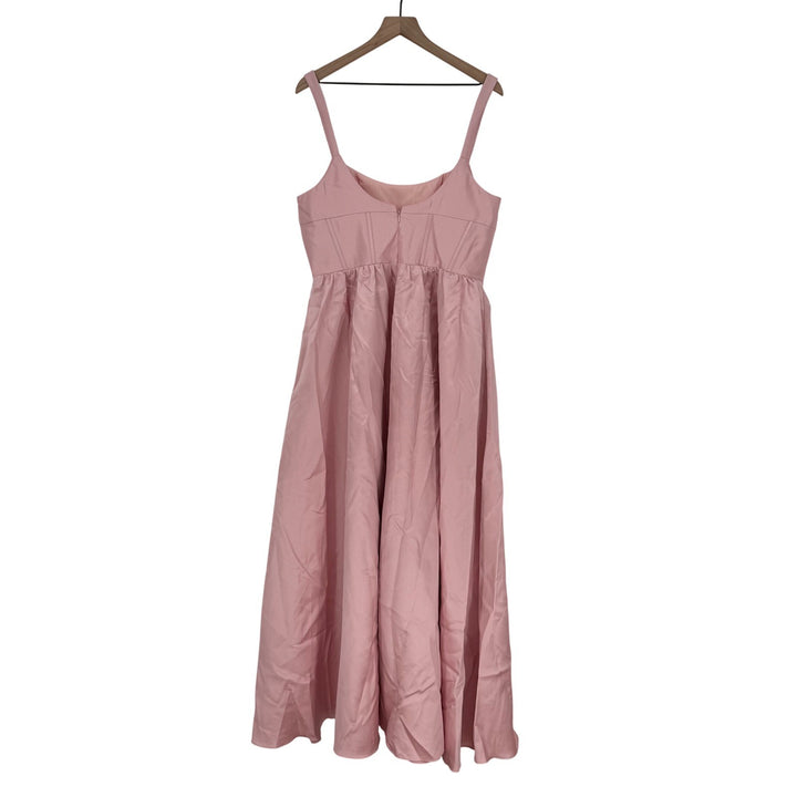 Pink dress on a hanger against a white background