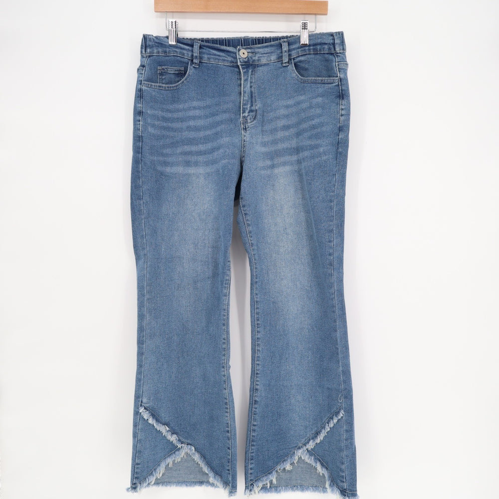 Blue jeans with frayed hems on a white background