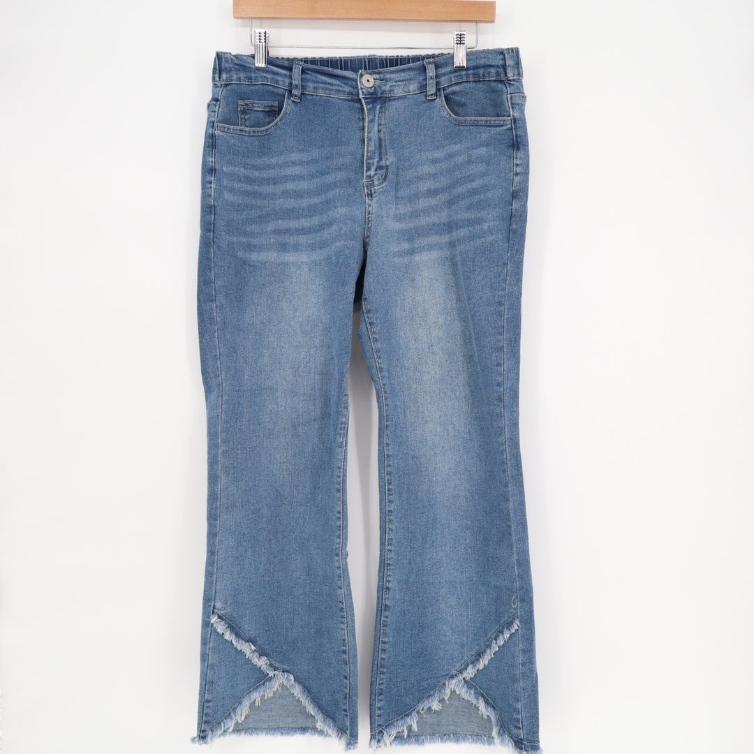 Blue jeans with frayed hems on a white background