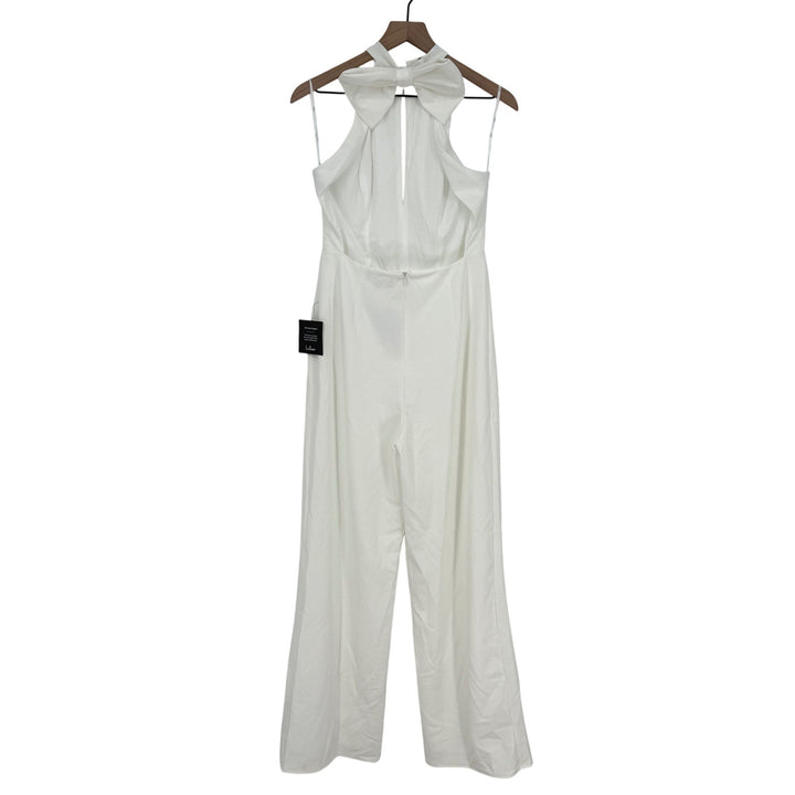 White sleeveless jumpsuit on a hanger against a white background