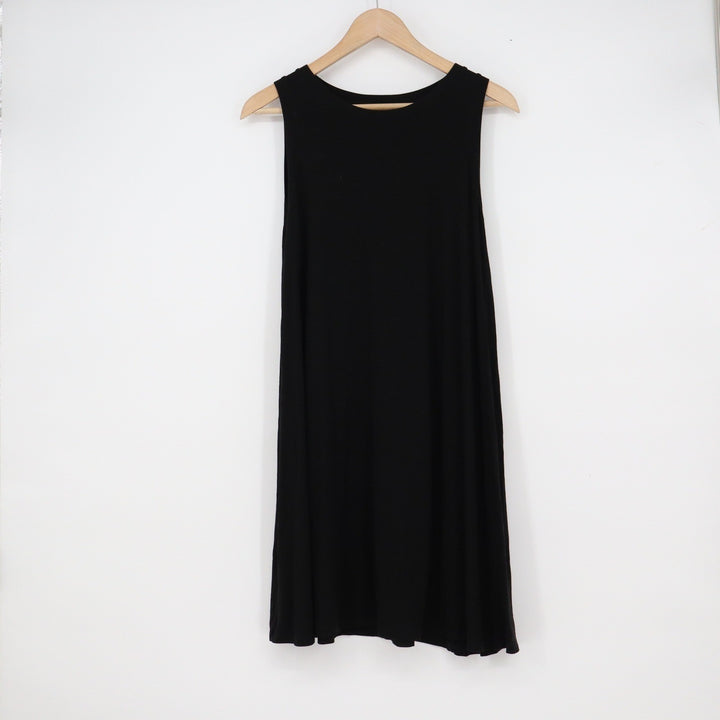 Black sleeveless dress on a wooden hanger against a white background