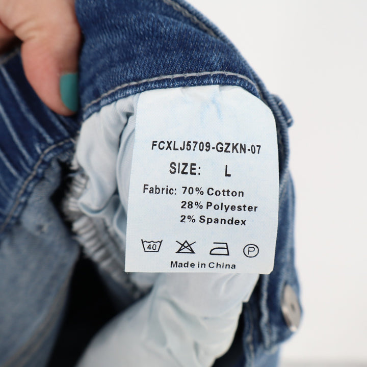 Fabric composition label on a denim jacket with a blurred background