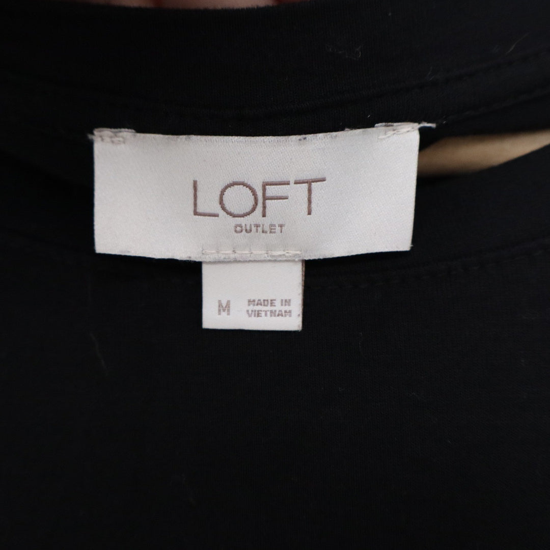 LOFT outlet tag on a black garment