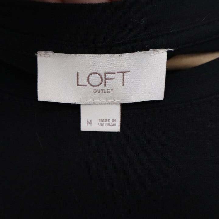LOFT outlet tag on a black garment