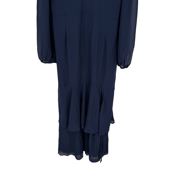Navy blue dress with layered skirt on a white background