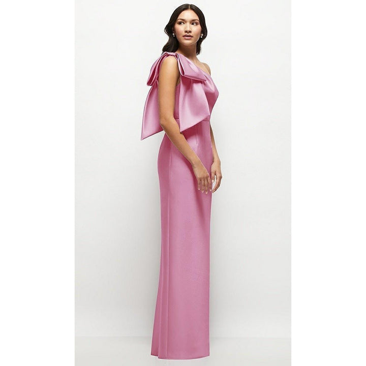 Woman wearing a pink one-shoulder dress on a white background