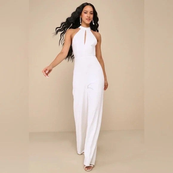 Woman wearing a white jumpsuit against a beige background
