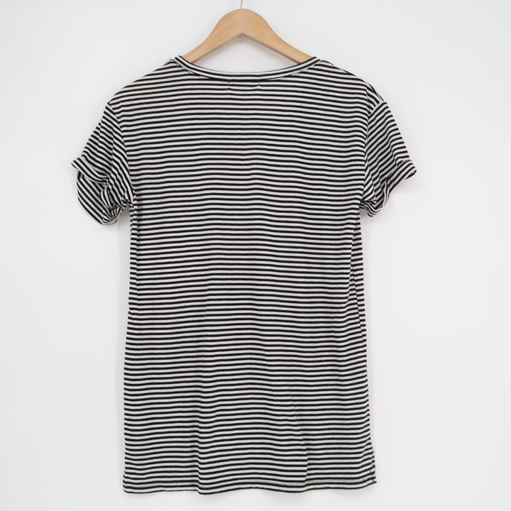 Black and white striped dress on a wooden hanger against a white background