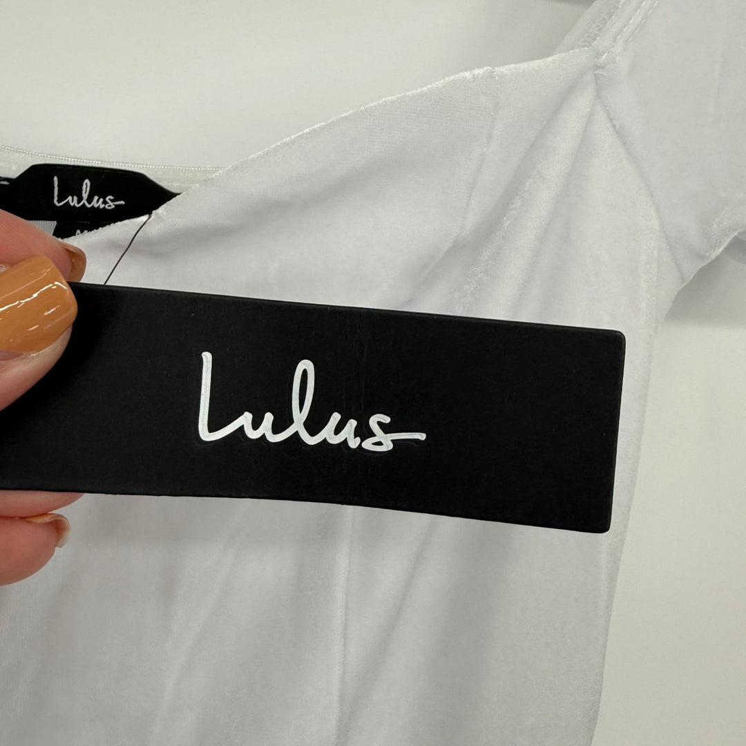 Black Lulus tag held over a white garment