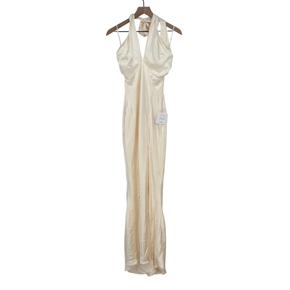 Beige evening gown on a hanger against a white background