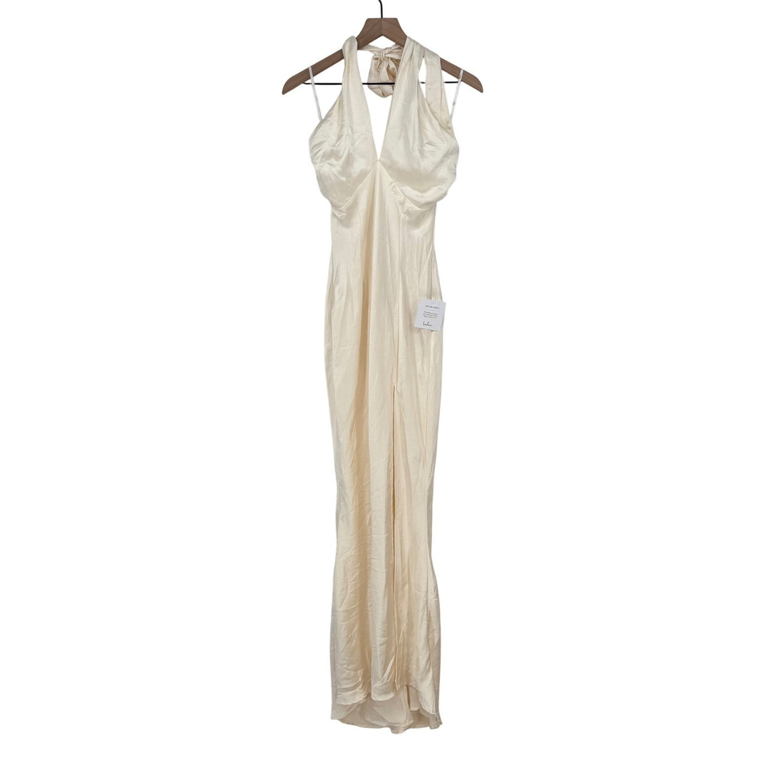 Beige evening gown on a hanger against a white background