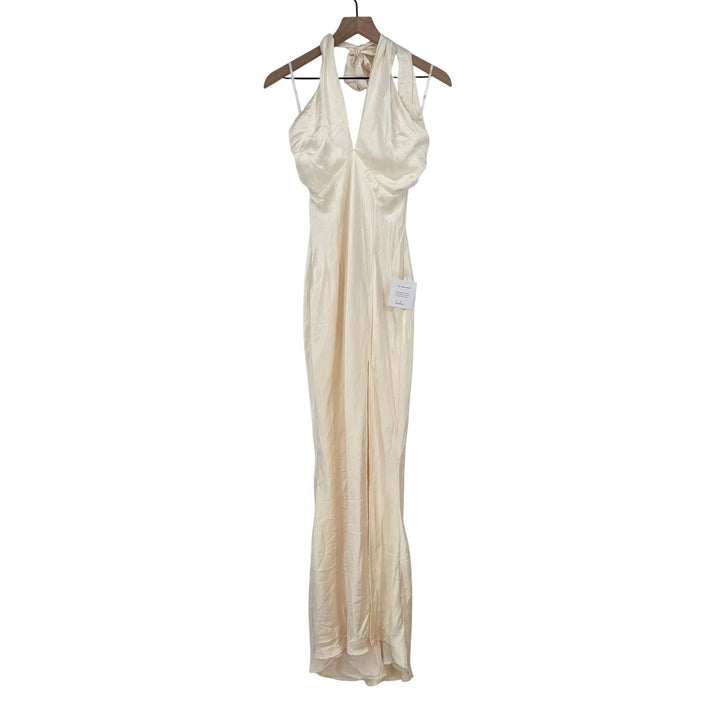 Beige evening gown on a hanger against a white background