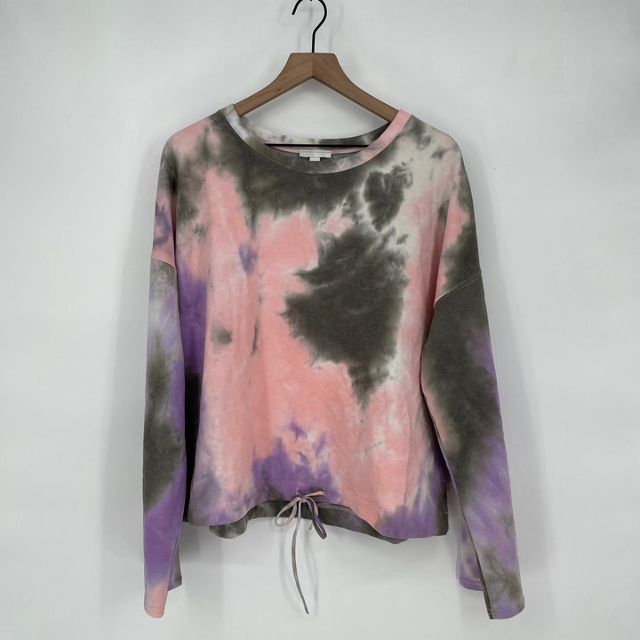 Tie-dye long-sleeve shirt on a hanger against a white background