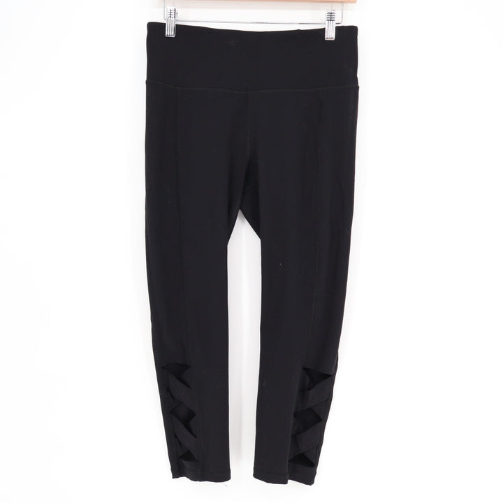 Gaiam Om Lotus Capri Leggings Womens Medium Black Stratch Cutout Hem High-Waist