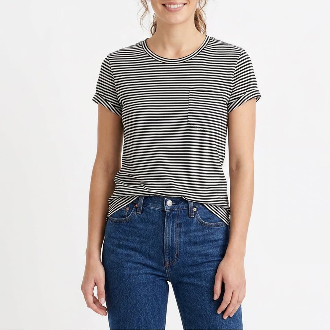 Woman wearing a black and white striped t-shirt and blue jeans on a white background
