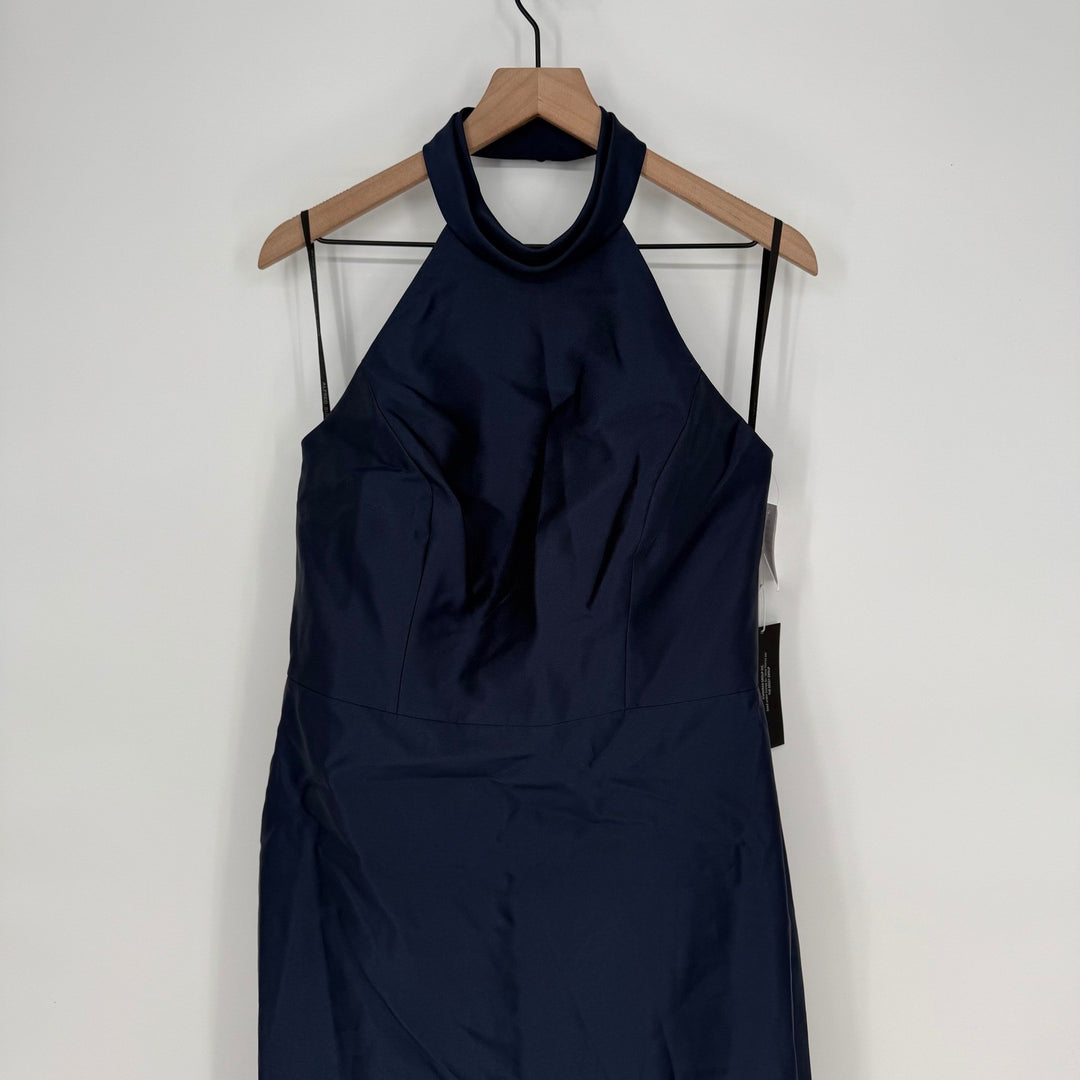 Navy blue dress on a wooden hanger against a white background