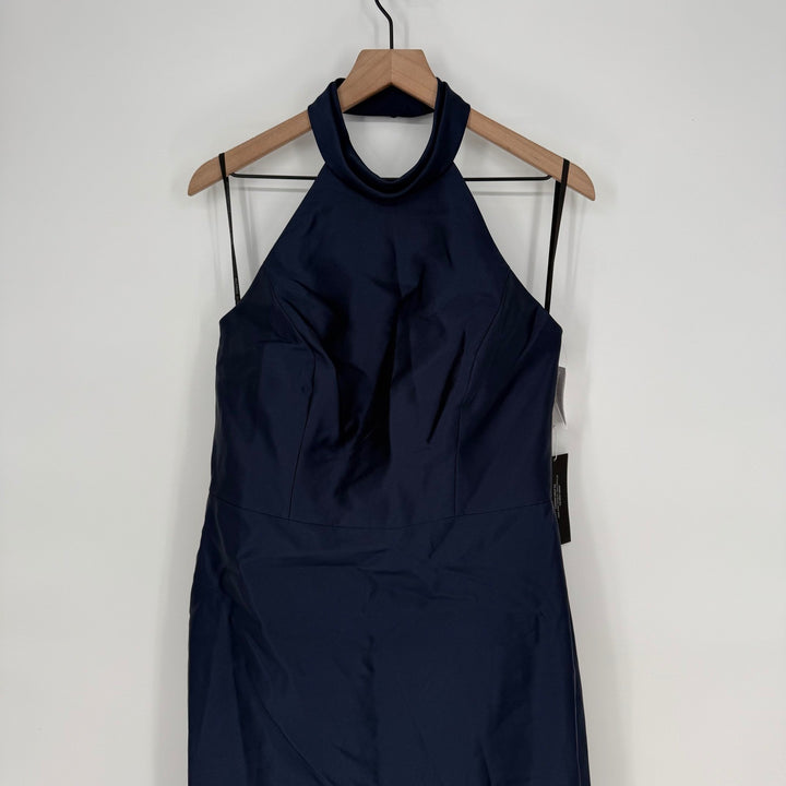 Navy blue dress on a wooden hanger against a white background