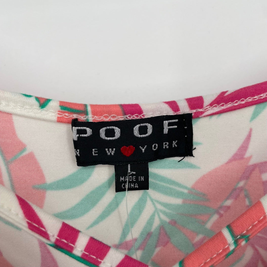 Label on a shirt with a colorful pattern, featuring the brand 'POOF'.