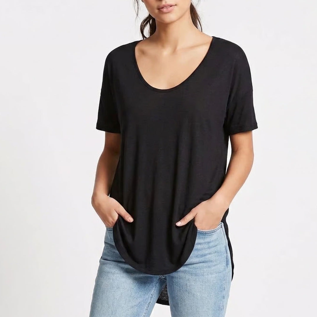 Person wearing a black t-shirt and light blue jeans on a white background