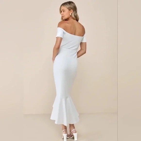 Woman wearing a white off-shoulder dress against a beige background