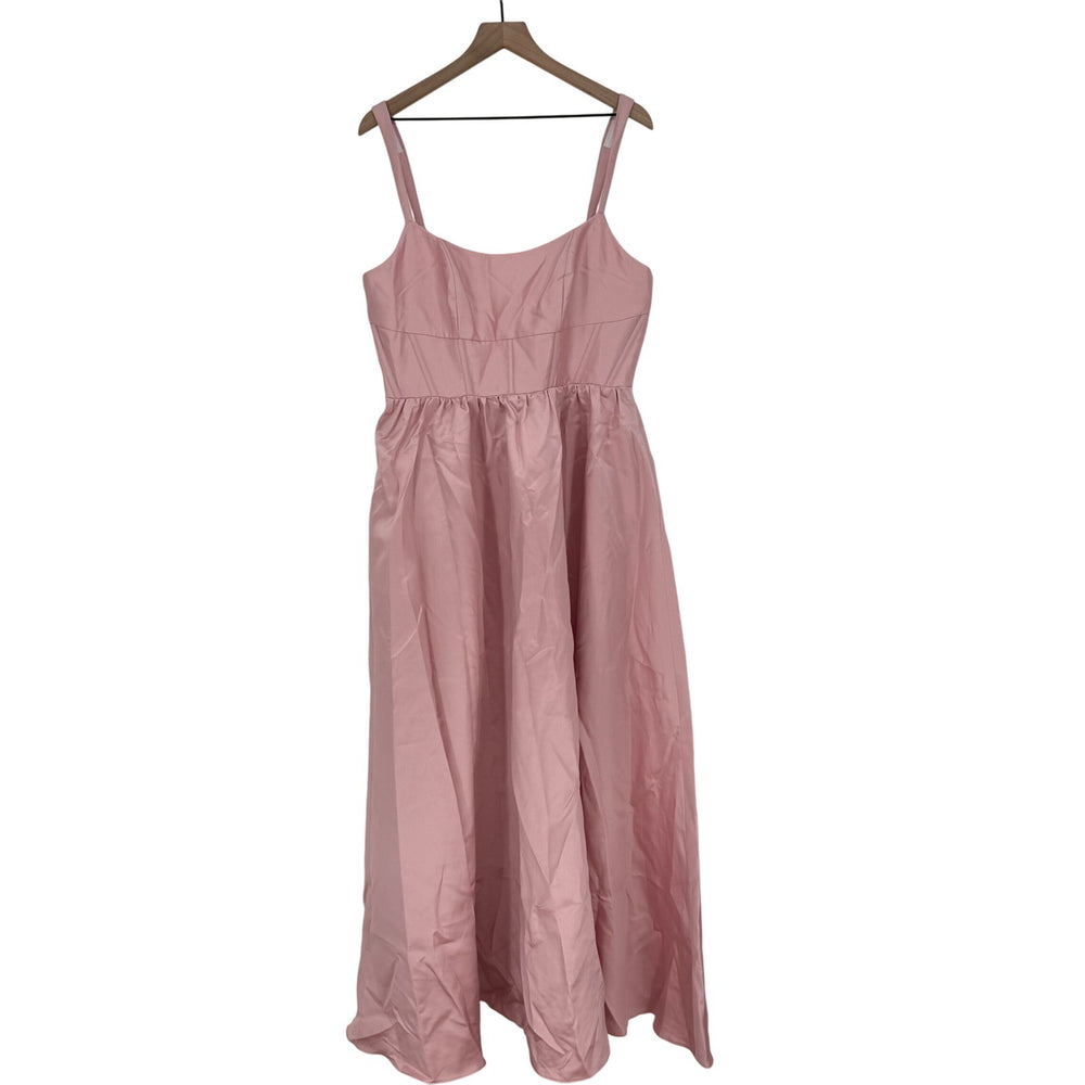 Pink dress on a hanger against a white background