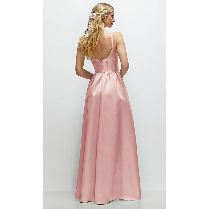 Woman wearing a pink evening gown with a white background