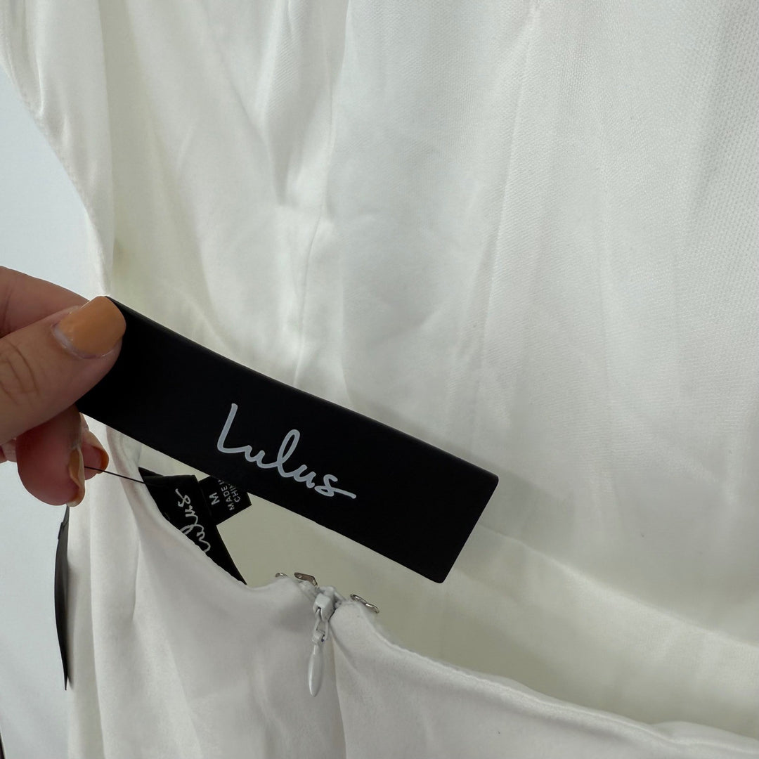 Close-up of a Lulus tag on a white garment with a light gray background