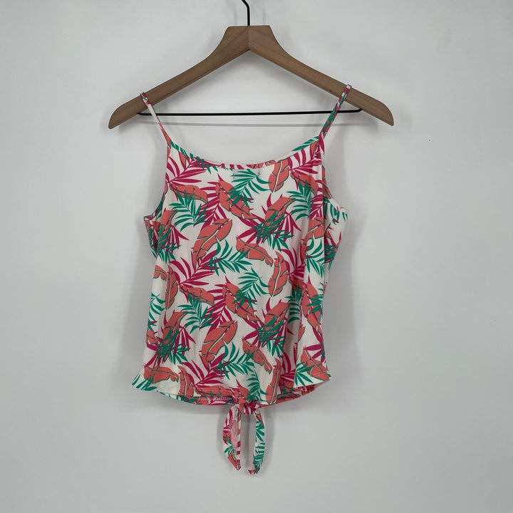 Floral patterned top on a wooden hanger against a plain background