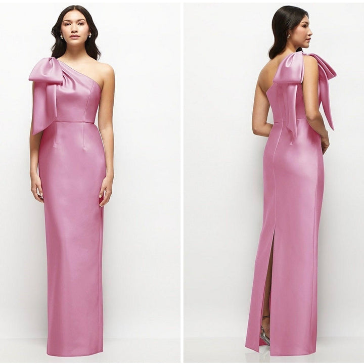 Pink one-shoulder gown with a large bow detail on a white background
