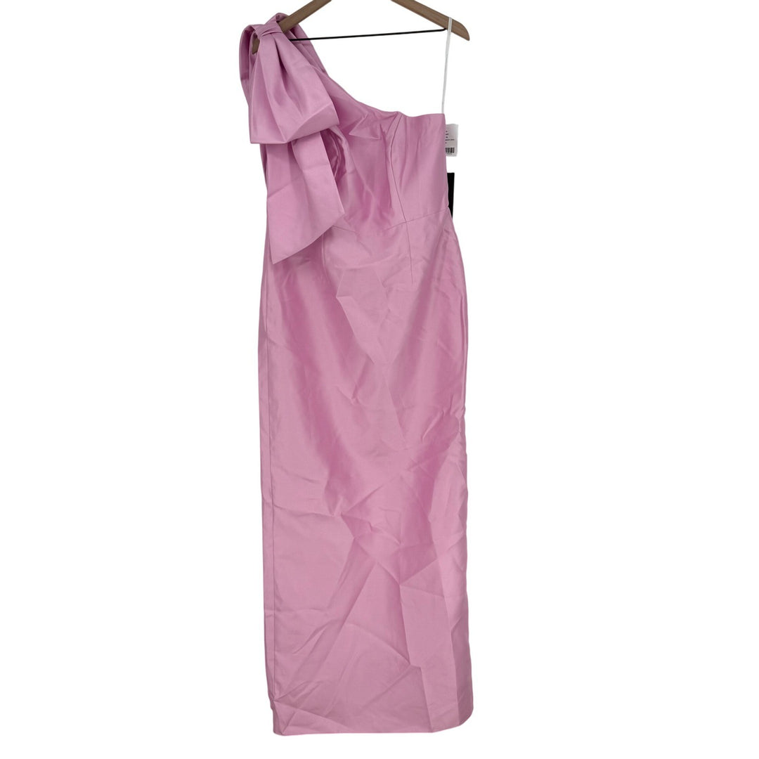 Pink one-shoulder dress on a hanger against a white background
