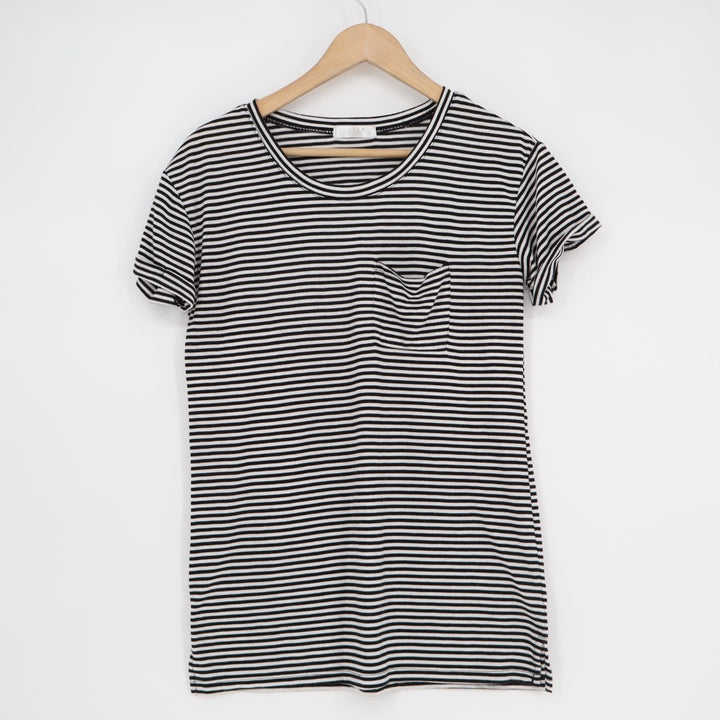 Black and white striped dress on a hanger against a white background
